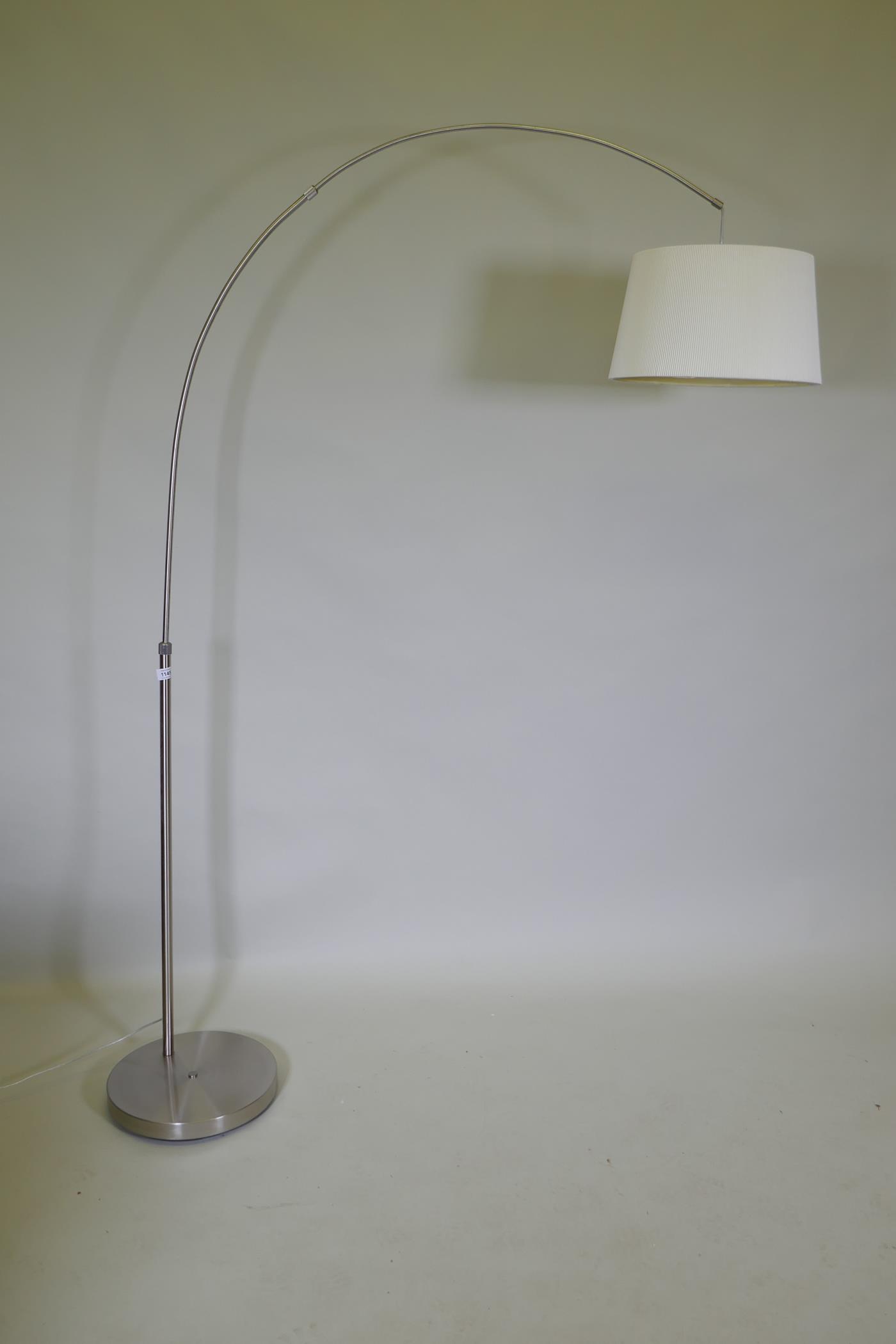 A contemporary brushed steel floor lamp, 180cm high