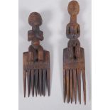 A pair of African Luba tribe combs with carved figural handles, largest 27cm
