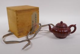 A Chinese Yixing tea pot of lobed form with protective wood box, impressed seal mark to base, 9cm