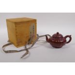 A Chinese Yixing tea pot of lobed form with protective wood box, impressed seal mark to base, 9cm