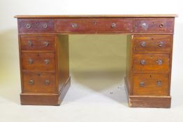 A Victorian mahogany nine drawer pedestal desk with gilt tooled leather inset top and ring pull