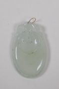 A Chinese translucent hardstone pendant with carved ruyi decoration and a yellow metal loop, 3 x 5cm