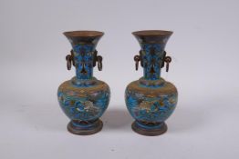 A pair of Chinese cloisonne two handled vases decorated with cranes and chrysanthemums, 18cm high