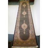 A deep black ground fine woven full pile Iranian runner with multicolour design, 100 x 408cm