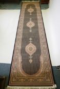 A deep black ground fine woven full pile Iranian runner with multicolour design, 100 x 408cm