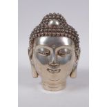 A Sino Tibetan filled white metal Buddha head, impressed 4 character mark to base, 16cm high