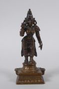 An Indian bronze figure of a female deity, 12cm high