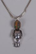 A silver Fumsup touch wud charm with glass eyes, 3cm long, on a silver chain