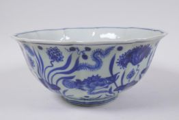 A blue and white porcelain bowl of lobed form decorated with carp in a lotus pond, Chinese Xuande