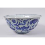 A blue and white porcelain bowl of lobed form decorated with carp in a lotus pond, Chinese Xuande