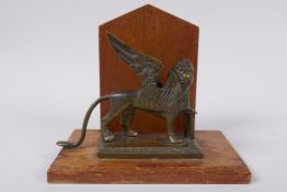 A mahogany letter rack mounted with a bronze griffin, 14cm high