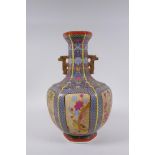 A Chinese polychrome porcelain two handled vase with decorative panels depicting birds,