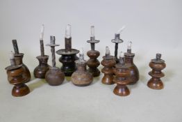 A collection of wood candlestick, largest 17cm high