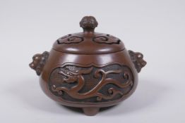 A Chinese bronze censer and cover with two lion mask handles and stylised decorative dragon