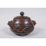 A Chinese bronze censer and cover with two lion mask handles and stylised decorative dragon