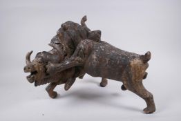 An antique hardwood carving of a lion taking down a water buffalo, AF losses, 34cm high