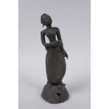 An antique Burmese bronze female figure, 21cm high