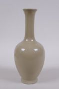 A Chinese porcelain vase with a buff glaze and slender neck, 20cm high