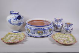 A collection of Italian majolica to include a bramble wine jug, leaf, shape dishes, a steep sided