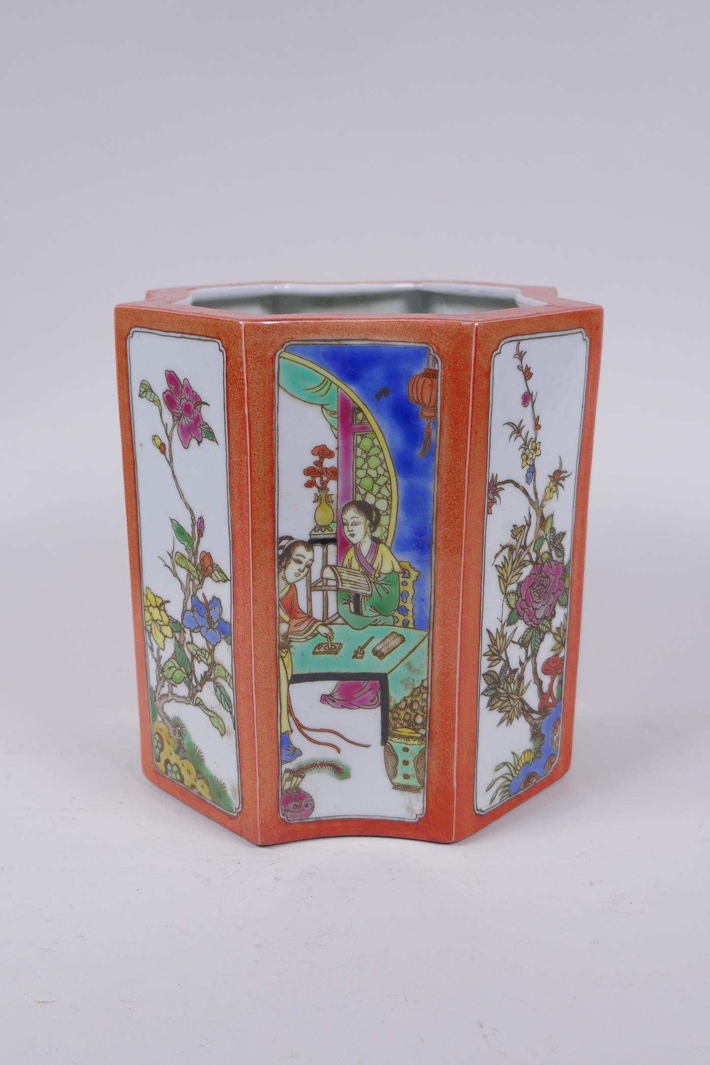 A Chinese shaped porcelain brush pot with famille vert decorative panels depicting figures and