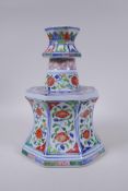 A Chinese wucai porcelain candlestick of octagonal form with decorative floral panels, 28cm high, AF