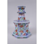 A Chinese wucai porcelain candlestick of octagonal form with decorative floral panels, 28cm high, AF