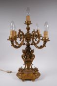 A gilt bronze four branch candelabra decorated with cherubic busts and swags, 56cm high