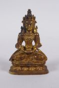 A Sino Tibetan gilt bronze figure of Buddha seated on a lotus throne, 7cm high