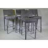 A set of four cane bar stools on chrome supports, 105cm high