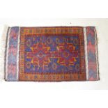 An antique Persian wool rug with a twin red and orange medallion design on a blue field, 82 x 132cm