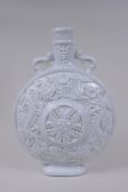 A Chinese blanc de chine porcelain two handled moon flask with raised and floral decoration,