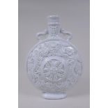 A Chinese blanc de chine porcelain two handled moon flask with raised and floral decoration,