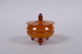 A faux butterscotch and honey amber pot and cover, 5cm diameter