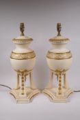 A pair of painted ceramic urn shaped table lamps with gilt details, 52cm high