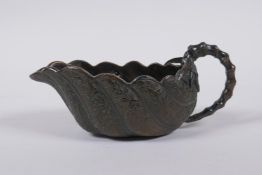 A Japanese bronze bamboo and leaf shaped cup/pourer, signed to base, 15cm long