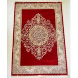 A rich ruby red ground full pile Qum rug with floral medallion pattern, 158 x 234cm