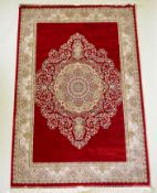A rich ruby red ground full pile Qum rug with floral medallion pattern, 158 x 234cm