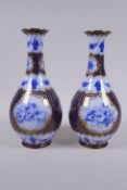 A pair of continental porcelain vases with blue and white cherubic panels within within deep blue
