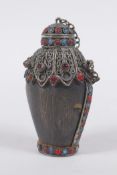 A Tibetan white metal mounted horn snuff bottle inset with semi precious stones, 9cm high
