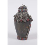 A Tibetan white metal mounted horn snuff bottle inset with semi precious stones, 9cm high