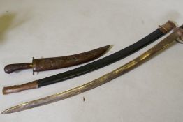 An Indian Sabre in canvas scabbard, and dagger in carved wood sheath, sword 90cm long
