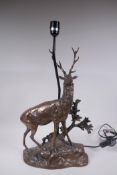 A bronzed composition lamp in the form of a stag, 62cm high without shade