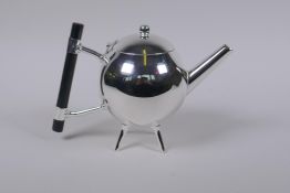 A Christopher Dresser style silver plated teapot with ebonised wood handles, 15cm high