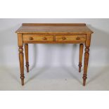 A satin birch two drawer writing table raised on turned tapered supports, 91 x 48cm, 75cm high