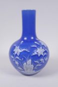 A Chinese blue ground porcelain bottle vase with white floral decoration, Qianlong seal mark, to