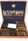 A Thai bronze and rosewood twelve place cutlery set in wood canteen, appears unused