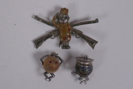 A touch wud charm of a Tommy with glass eyes, (lacks arm) 2cm long, and another similar, and a white