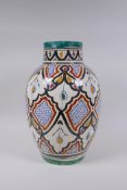 A North African hand painted terracotta vase, signed to the base, 34cm high