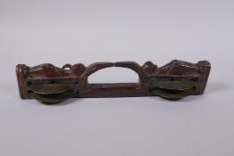 An antique Indian carved wood and brass Khartal percussion cymbal, 27cm long