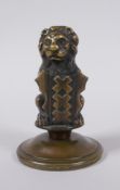 A bronze heraldic mount in the form of a lion with a shield, 10cm high